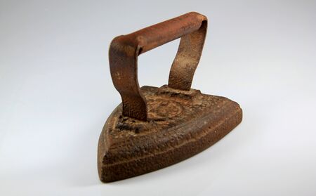 Old rusted iron useful for ironing clothesの写真素材