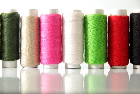 Spools of colored cotton thread to sew clothes and moreの写真素材