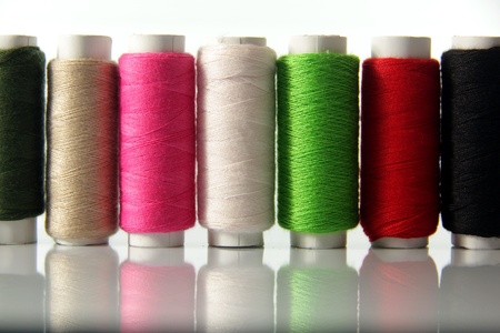 Spools of colored cotton thread to sew clothes and moreの写真素材