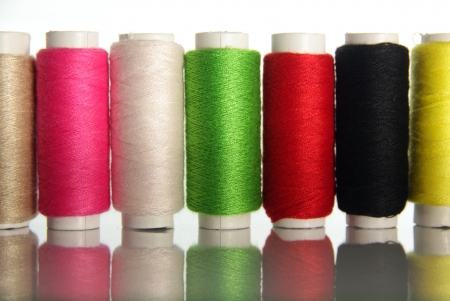 Spools of colored cotton thread to sew clothes and moreの写真素材