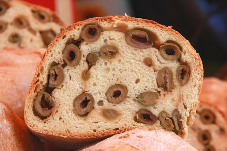 Close-up of a piece of salted bread with olivesの写真素材