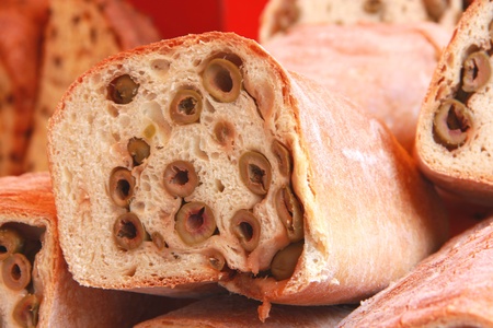 Close-up of a piece of salted bread with olivesの写真素材