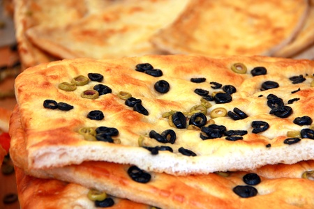 Close-up of a piece of salted bread with olivesの写真素材