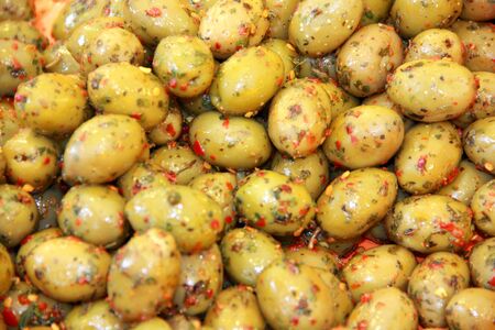 A bunch of olives with red pepperの写真素材