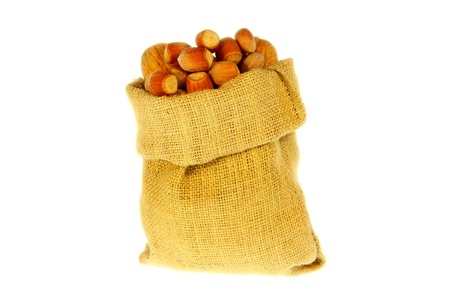 Jute bag full of walnuts and nuts with white backgroundの写真素材