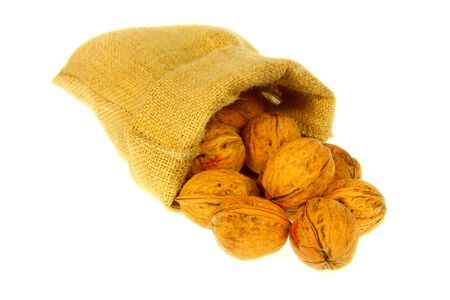 Jute bag full of walnuts with white backgroundの写真素材