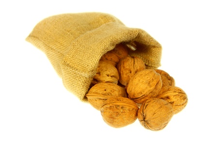 Jute bag full of walnuts with white backgroundの写真素材