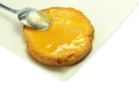 Tasty toast with honey with white backgroundの写真素材