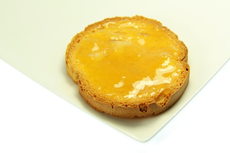 Tasty toast with honey with white backgroundの写真素材