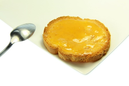 Tasty toast with honey with white backgroundの写真素材