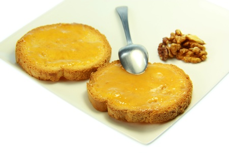 Tasty toast with honey with white backgroundの写真素材