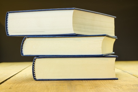 Three books on the wooden table の写真素材