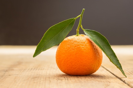 A closeup of a mandarin on a table