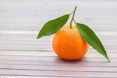 A closeup of a mandarin on a tableの写真素材