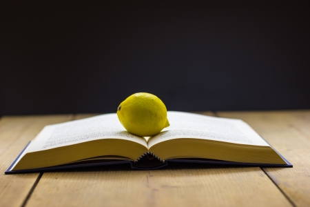 Book with lemon on the wooden table の写真素材
