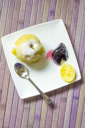 A plate with a baked apples and homemade plum jamの写真素材