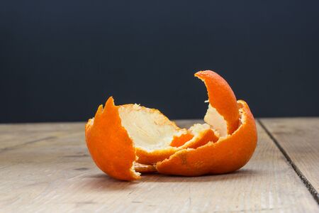 Tangerine peel on the table in front of a windowの写真素材