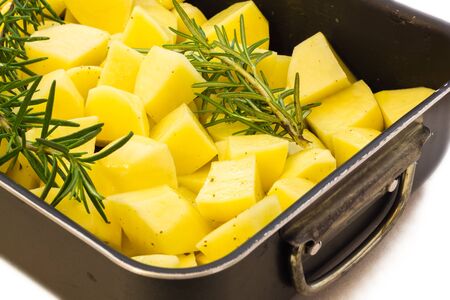 Baked potatoes with rosemary ready to be cookedの写真素材
