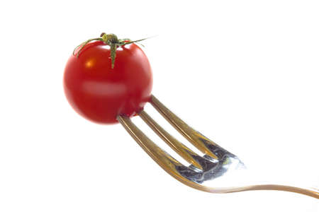 Close up view of a fork with red tomatoeの写真素材