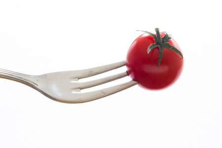 Close up view of a fork with red tomatoe