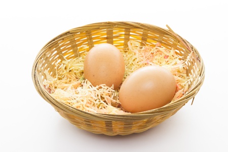 Some eggs in a basket with white backgroundの写真素材