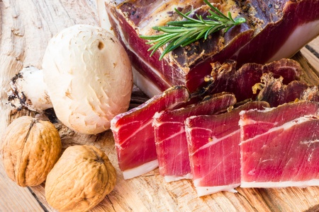 Tasty slices of Italian speck with rosemaryの写真素材