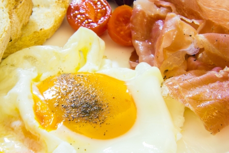 Cose up view of fried eggs with baconの写真素材