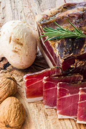 Tasty slices of Italian speck with rosemaryの写真素材
