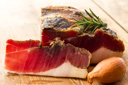 Tasty slices of Italian speck with rosemaryの写真素材
