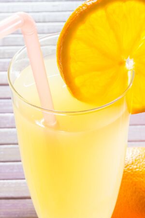 Fresh and colorful orange juice in a glassの写真素材