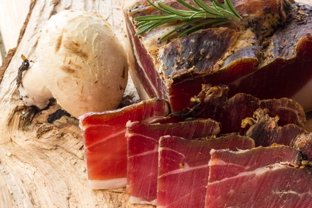 Tasty slices of Italian speck with rosemaryの写真素材