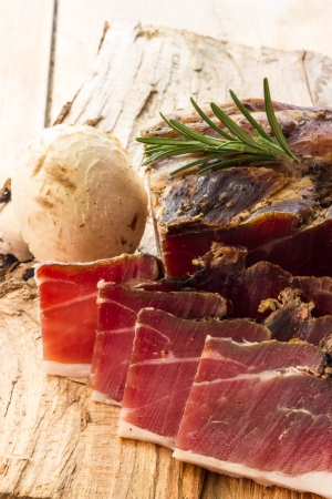 Tasty slices of Italian speck with rosemaryの写真素材