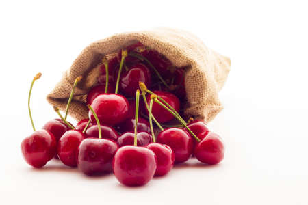 Ripe red cherry berries with white backgroundの写真素材