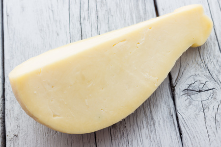 Slice of scamorza cheese from Italyの写真素材