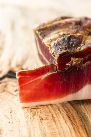 Tasty slices of Italian speck with rosemaryの写真素材