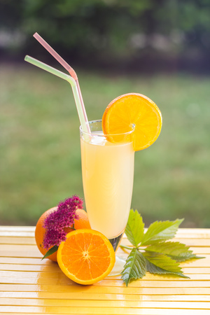 Fresh and colorful orange juice in a glassの写真素材