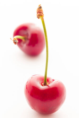 Ripe red cherry berries with white backgroundの写真素材