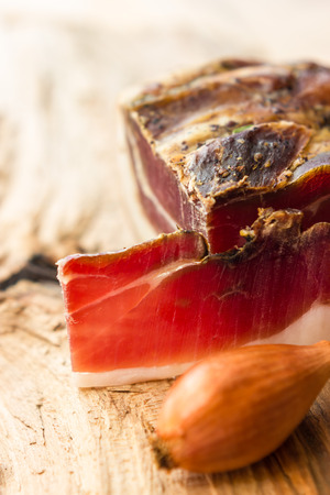 Tasty slices of Italian speck with rosemaryの写真素材
