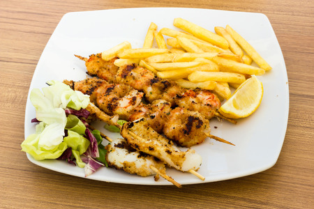 Seafood skewers with chipsの写真素材