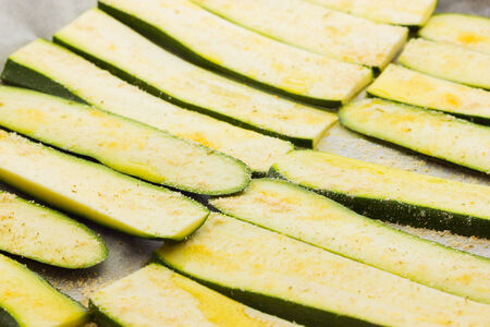 Sliced zucchinis ready to be bakedの写真素材
