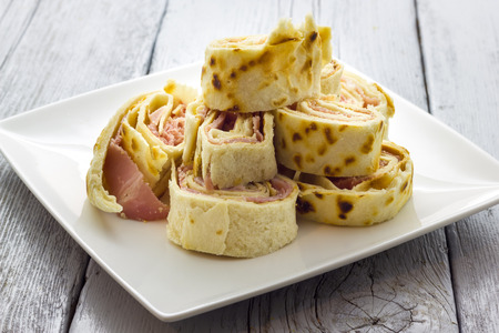 Roll of piadina with ham and cheeseの写真素材