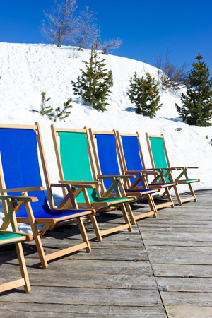 Sun beds in the snow mountainの写真素材