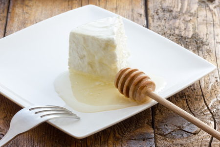 Tasty fresh cow Ricotta cheese with honeyの写真素材