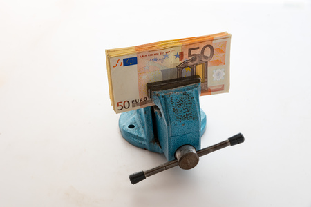 Euro under pressure in the gripの写真素材