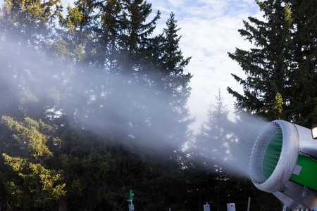 Cannon fires snow on the ski slopes