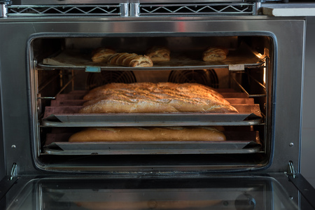Bread baking in the ovenの写真素材