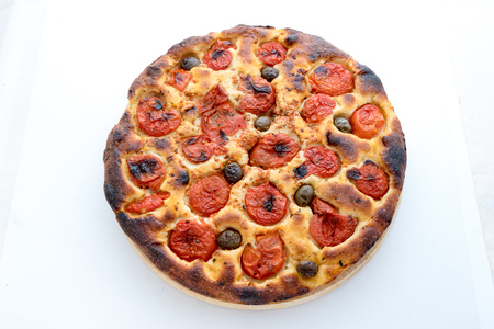 Focaccia typical of Bari Italy with tomatoes and oliveの写真素材