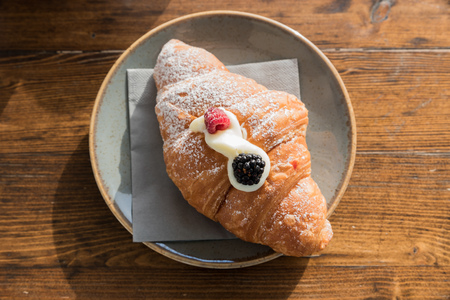 Croissant with cream of mascarpone and berriesの写真素材