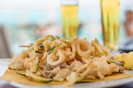 Fried mixed fish with ice-cold beerの写真素材