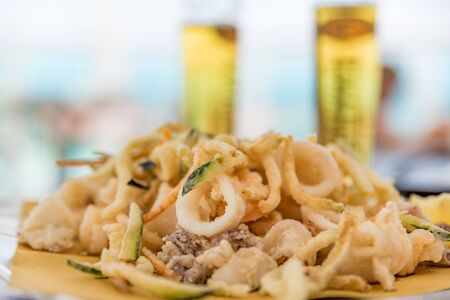 Fried mixed fish with ice-cold beer